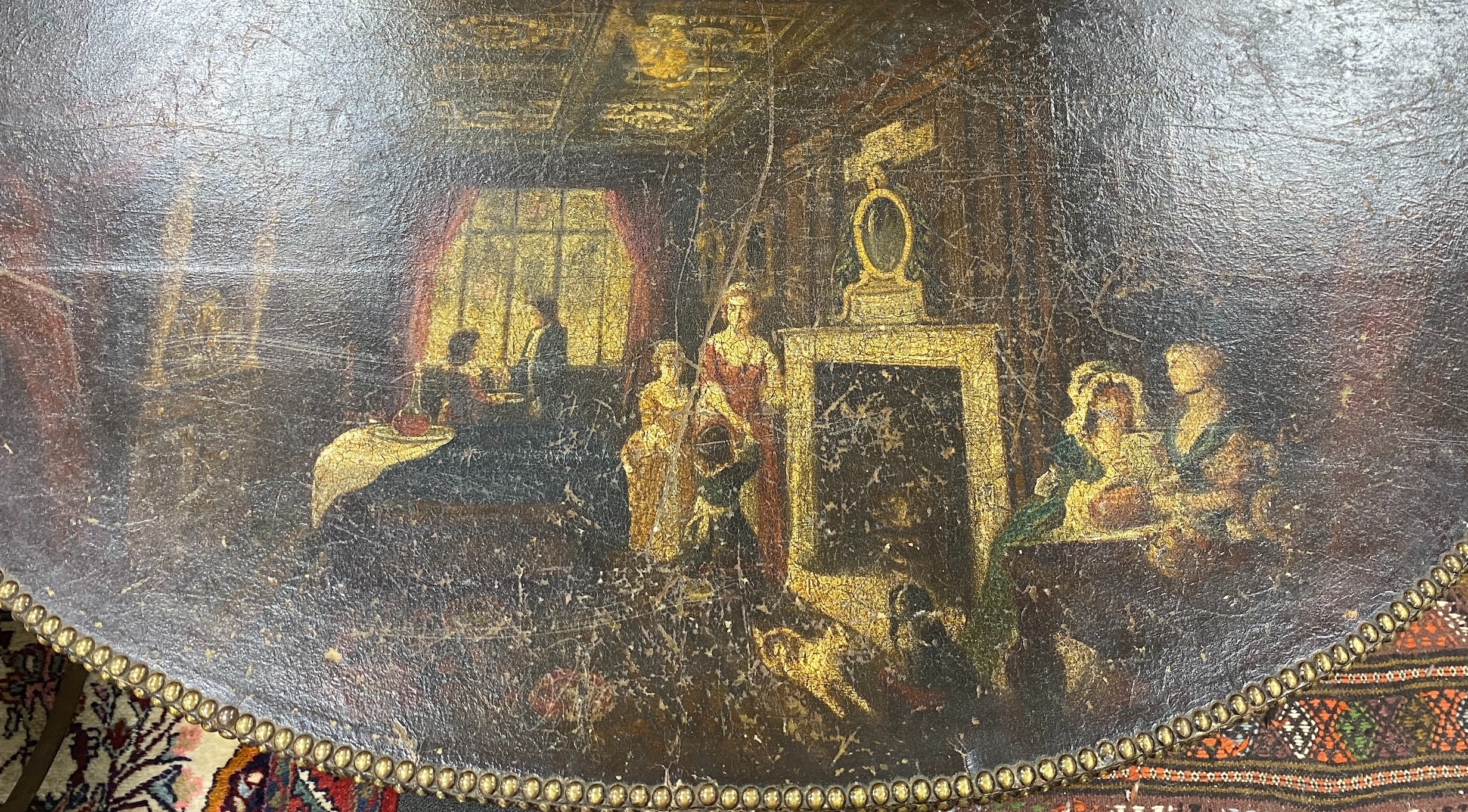 A late 19th / early 20th century studded painted leather d-shaped trunk, painted with tavern and interior scenes, on mahogany stand with carved claw and ball feet, width 112cm depth 54cm height 88cm